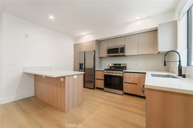 a view of a kitchen with wooden floor