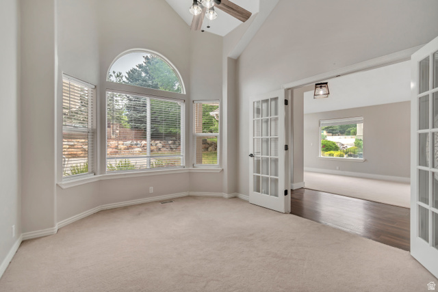 2154 Wasatch Boulevard Sandy, UT 84092 - Photo 6 of 55 Carpeted empty room with high vaulted ceiling, french doors, and ceiling fan
