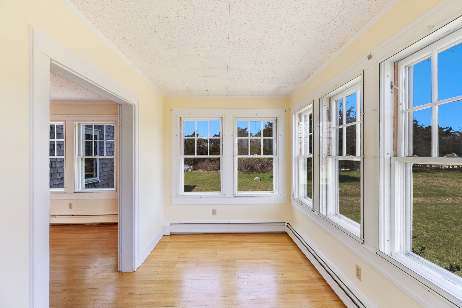 181 Polpis Road Nantucket, MA 02554 - Photo 14 of 22 a view of an empty room with a window and wooden floor