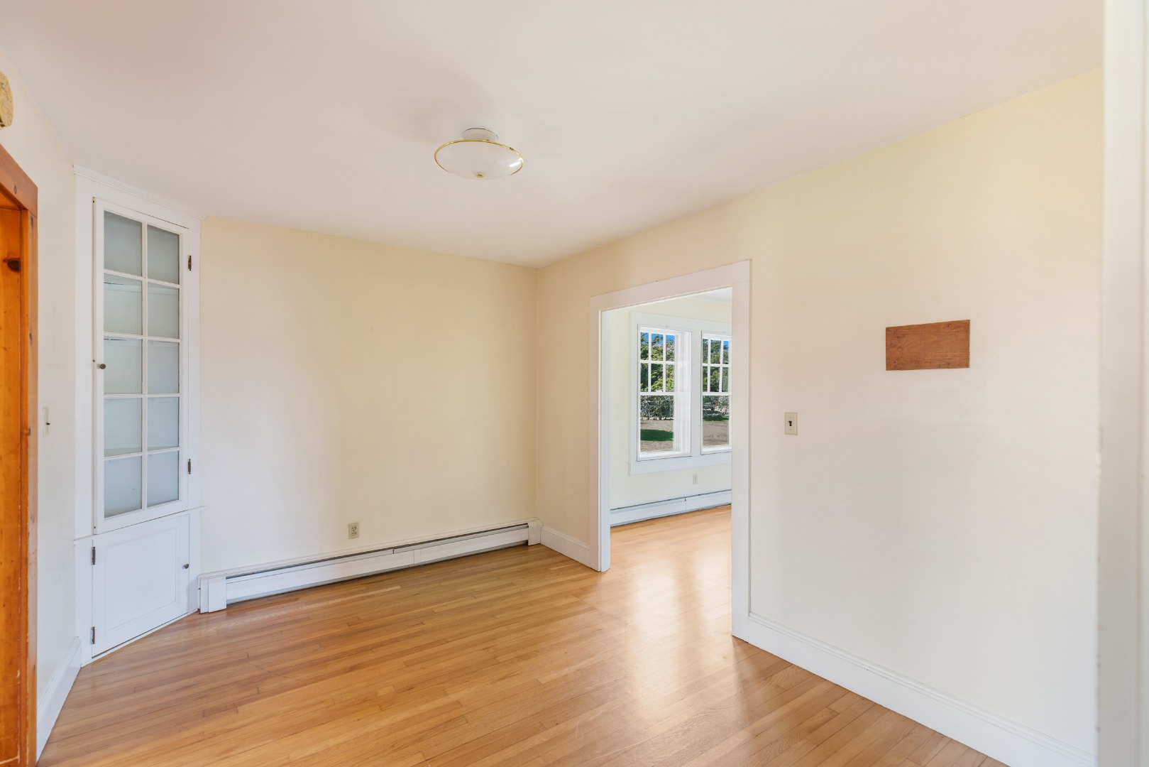 181 Polpis Road Nantucket, MA 02554 - Photo 15 of 22 an empty room with wooden floor and windows