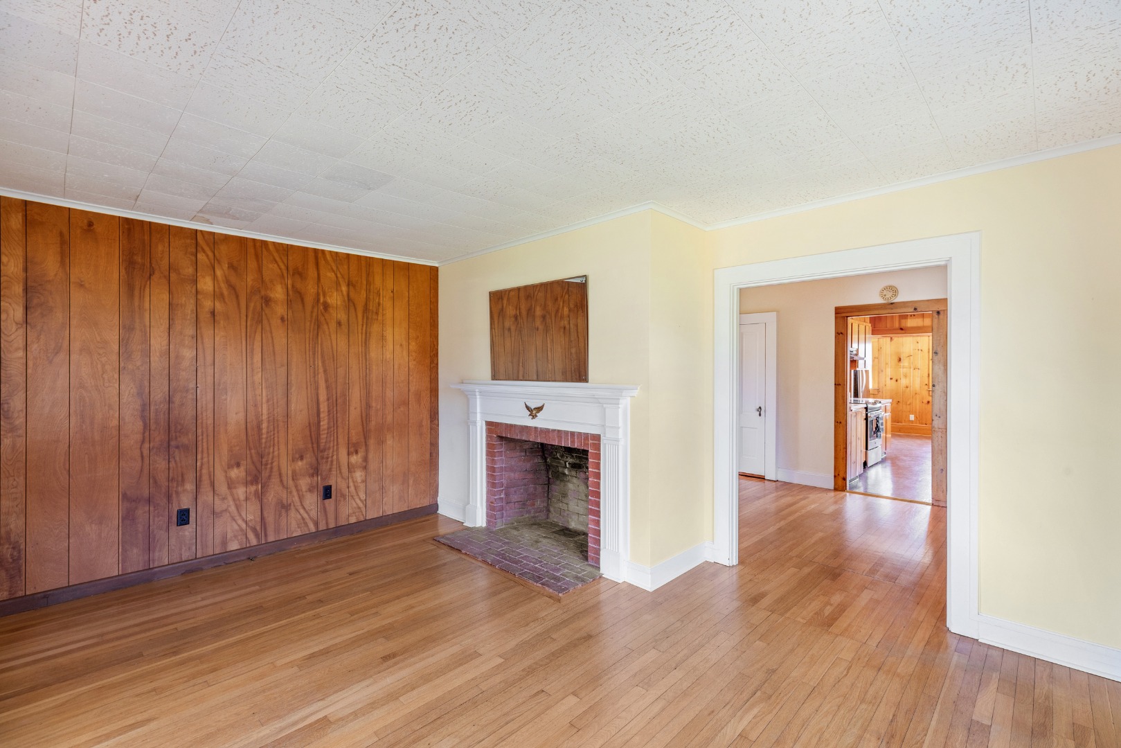 181 Polpis Road Nantucket, MA 02554 - Photo 18 of 22 a view of an empty room with wooden floor fireplace and a window