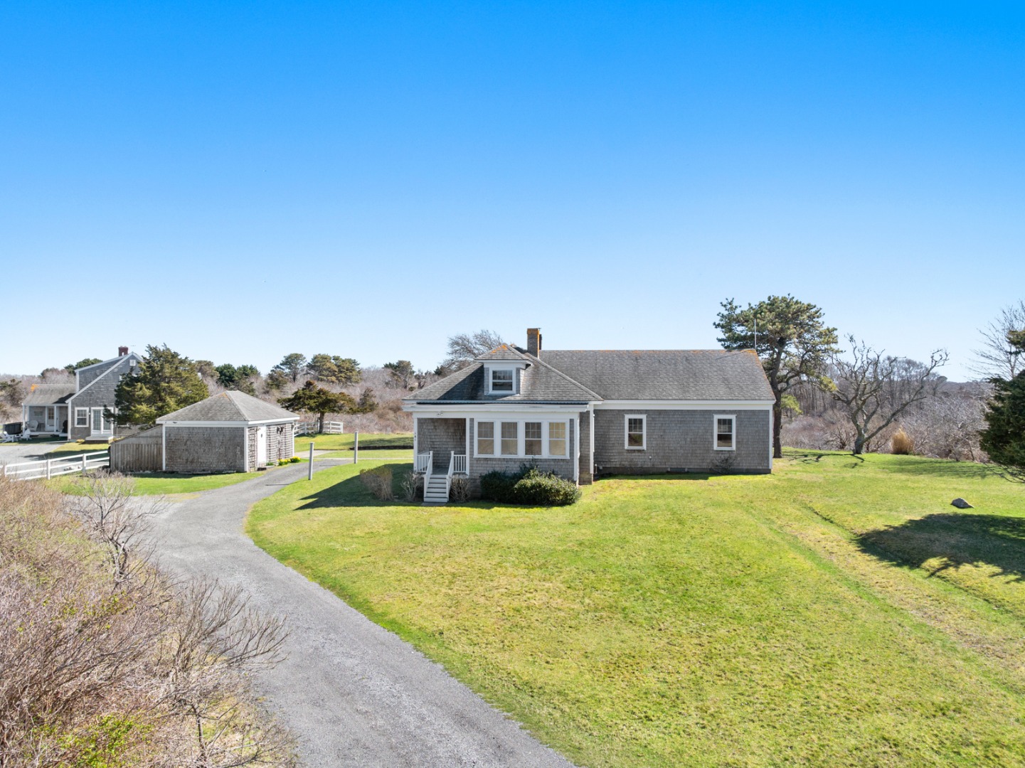 181 Polpis Road Nantucket, MA 02554 - Photo 9 of 22 a front view of a house with a yard and large trees