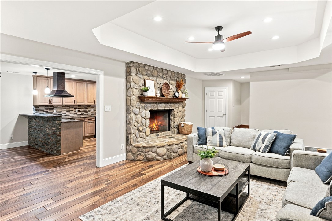 320 Watson Road Easley, SC 29642 - Photo 33 of 50 Rich hardwood floors lead into an inviting living space featuring a floor-to-ceiling stone fireplace.