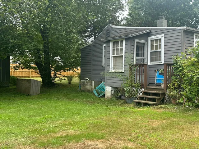 a view of a house with backyard porch and sitting area
