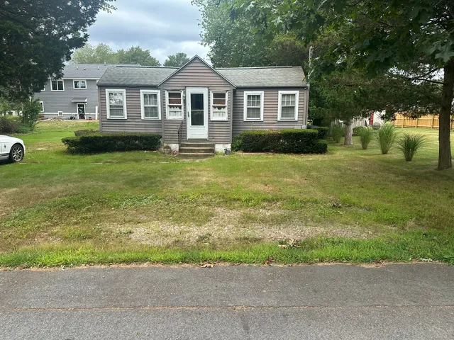 a front view of a house with a yard