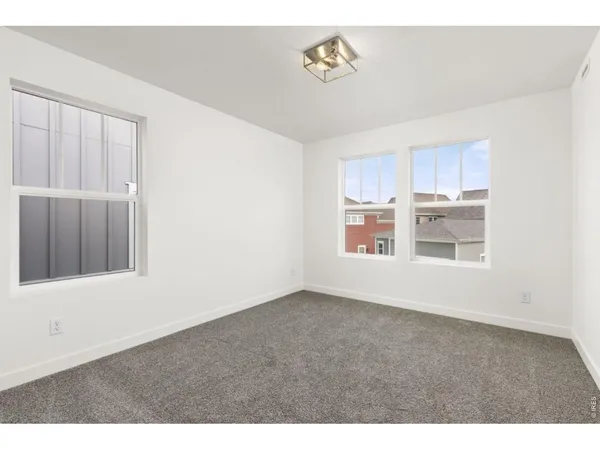 a bathroom with a toilet a sink a mirror and vanity