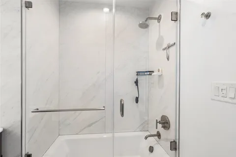 a bed sitting in a bedroom and a mirror