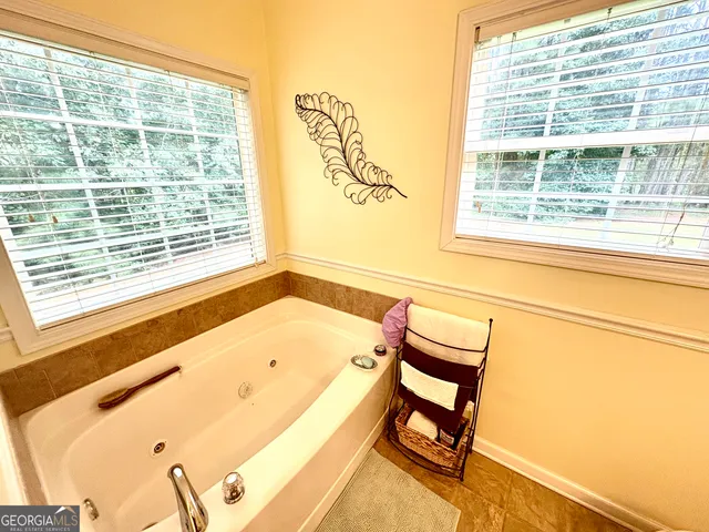 a bathroom with a tub and a window