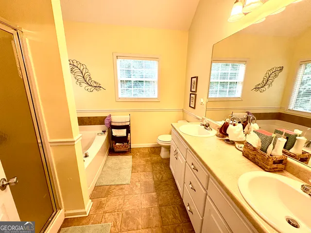 a bathroom with a tub sink and a mirror