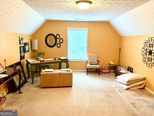 a bedroom with a bed and a refrigerator