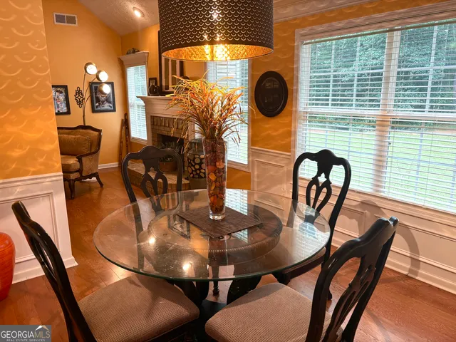 a view of a dining room with furniture and chandelier