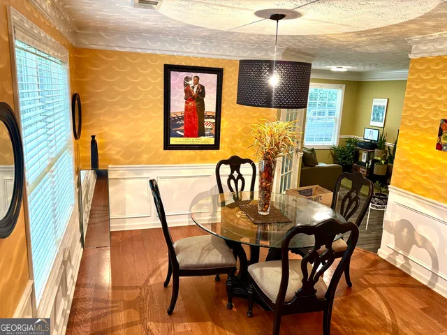 a view of a dining room with furniture and wooden floor
