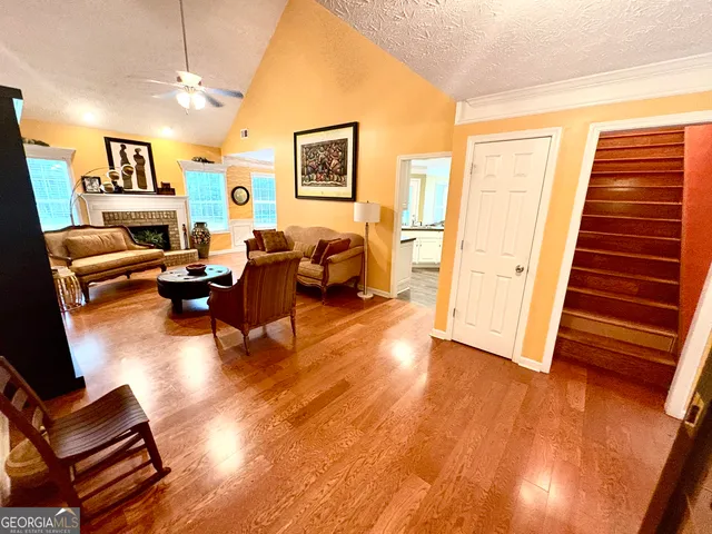 a living room with furniture and wooden floor