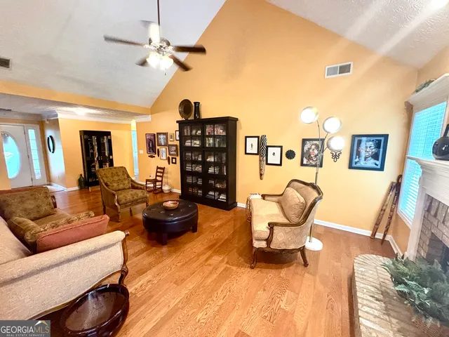 a living room with furniture a rug and a chandelier