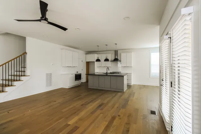 a view of a kitchen with a sink cabinets and wooden floor