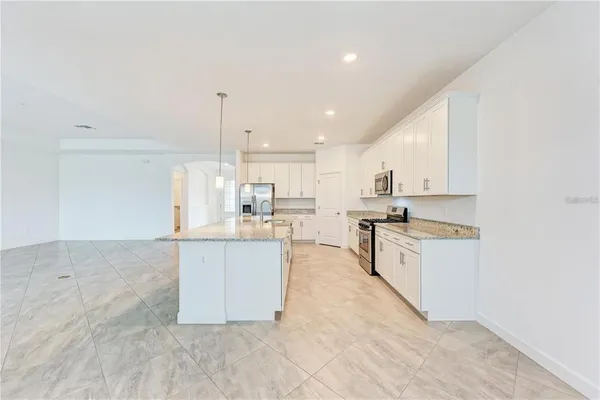 a kitchen with stainless steel appliances cabinets a sink and a counter top