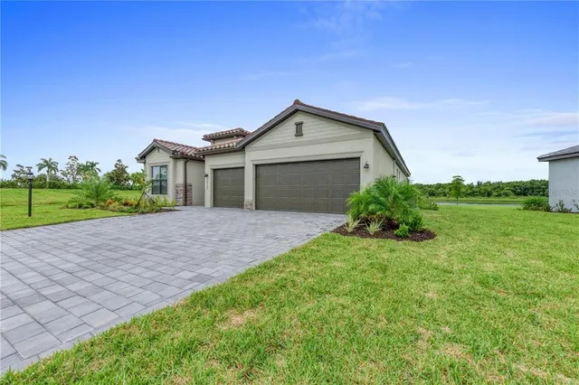 a front view of a house with a yard and garage