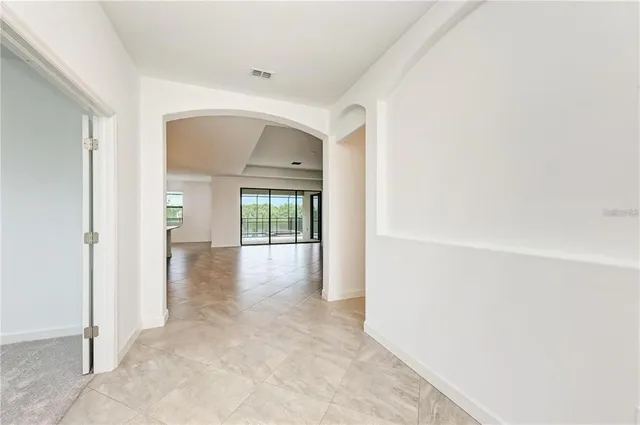 a view of a hallway with wooden shelves