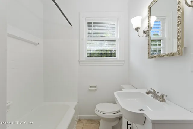a bathroom with a sink toilet and a mirror