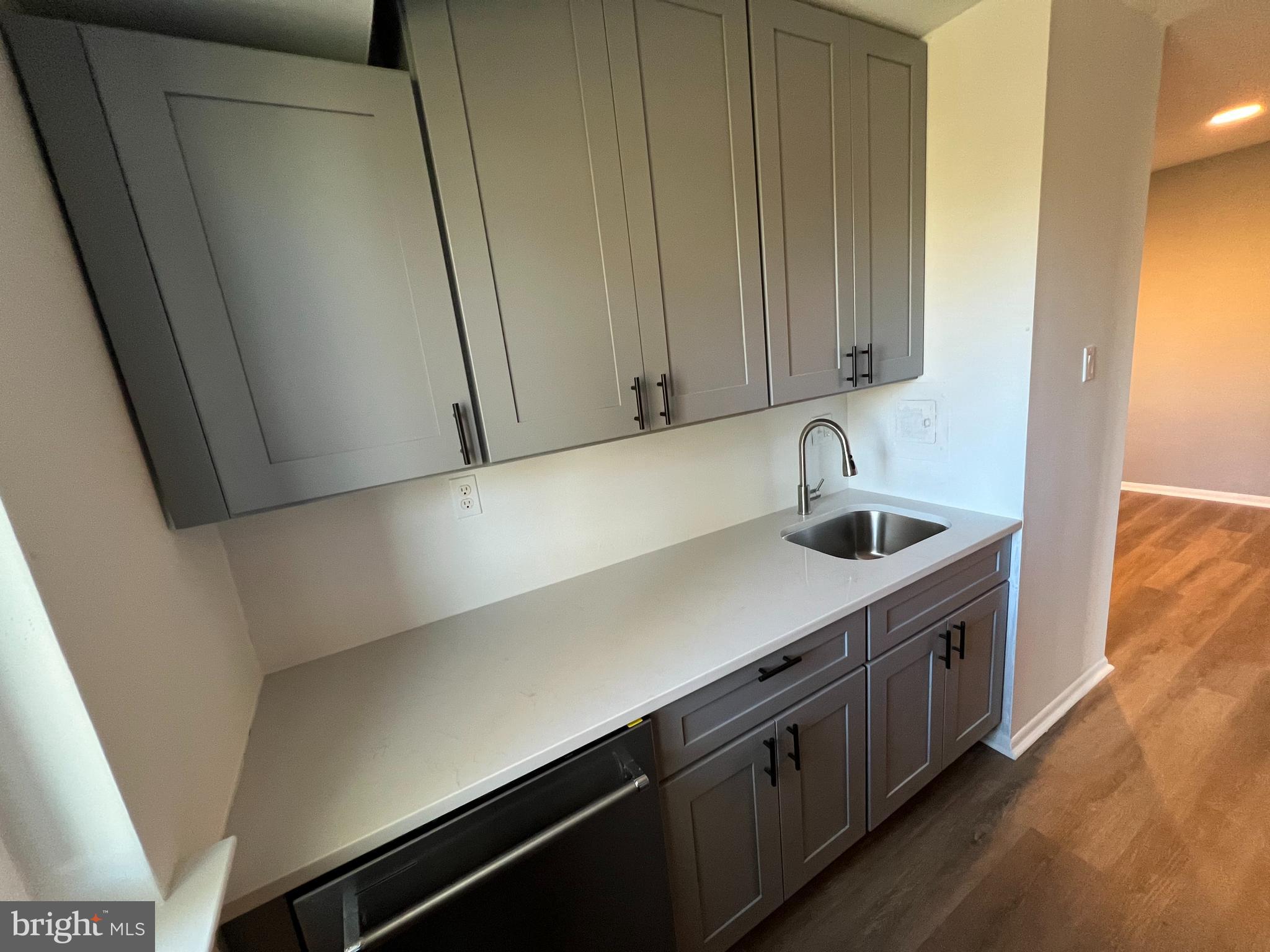 9921 Bustleton Avenue, Unit Q9 Philadelphia, PA 19115 - Photo 11 of 19 a kitchen with a sink and cabinets