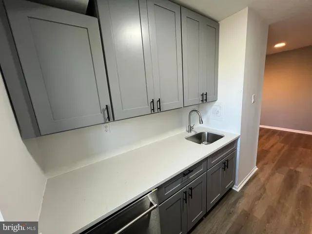 a kitchen with a sink and cabinets