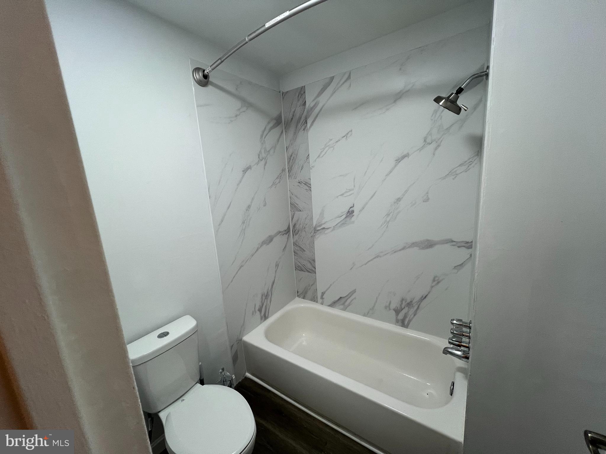 9921 Bustleton Avenue, Unit Q9 Philadelphia, PA 19115 - Photo 15 of 19 a white toilet sitting next to a bath tub