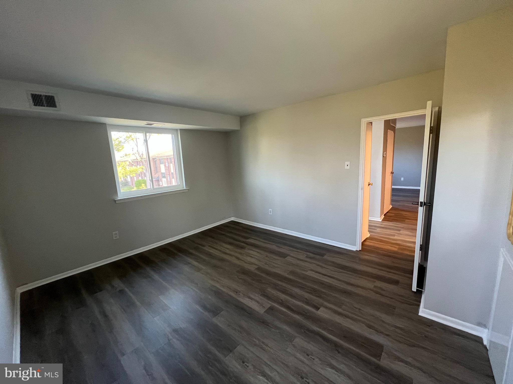 9921 Bustleton Avenue, Unit Q9 Philadelphia, PA 19115 - Photo 17 of 19 an empty room with wooden floor and windows