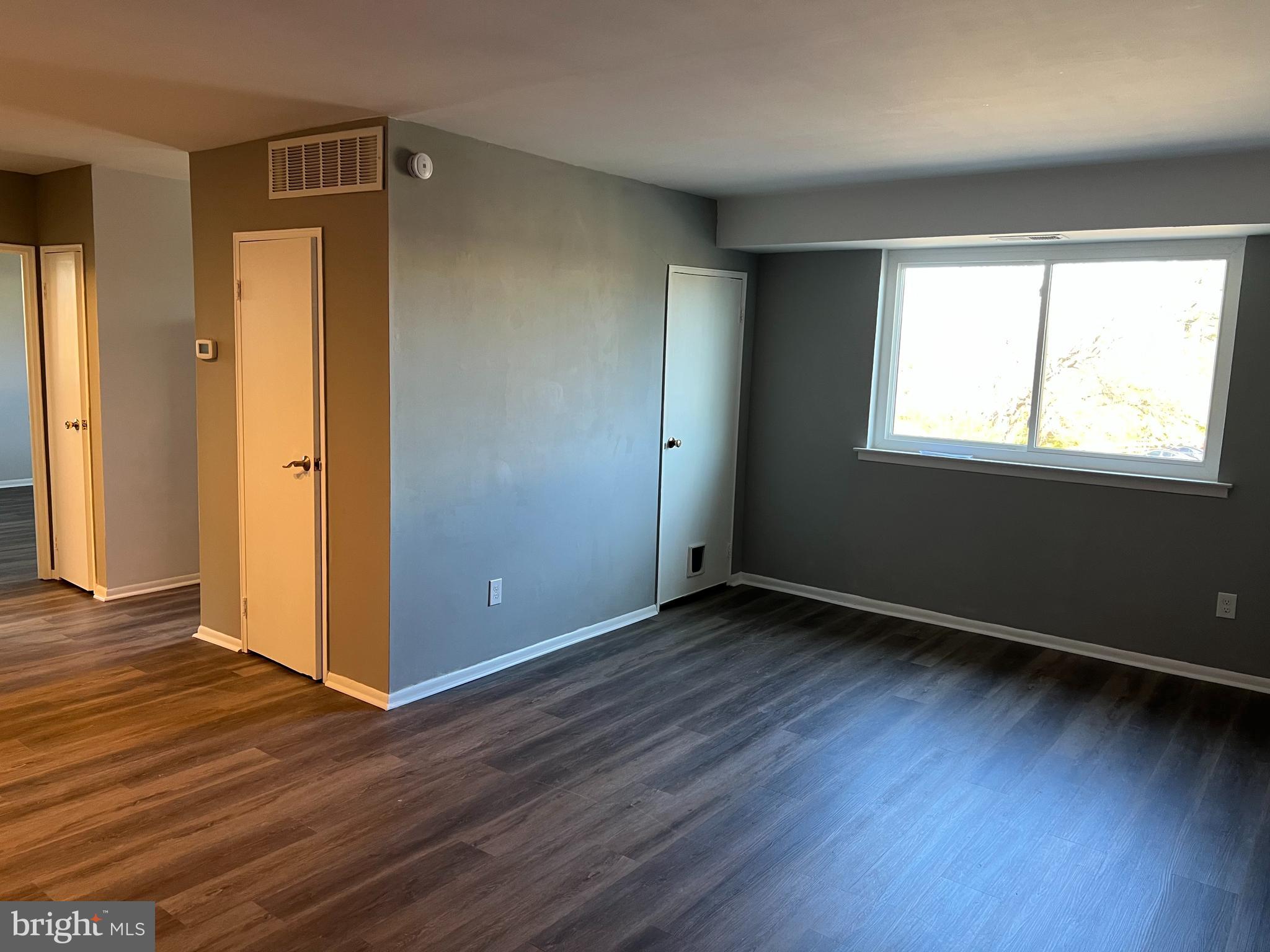 9921 Bustleton Avenue, Unit Q9 Philadelphia, PA 19115 - Photo 4 of 19 an empty room with wooden floor and windows
