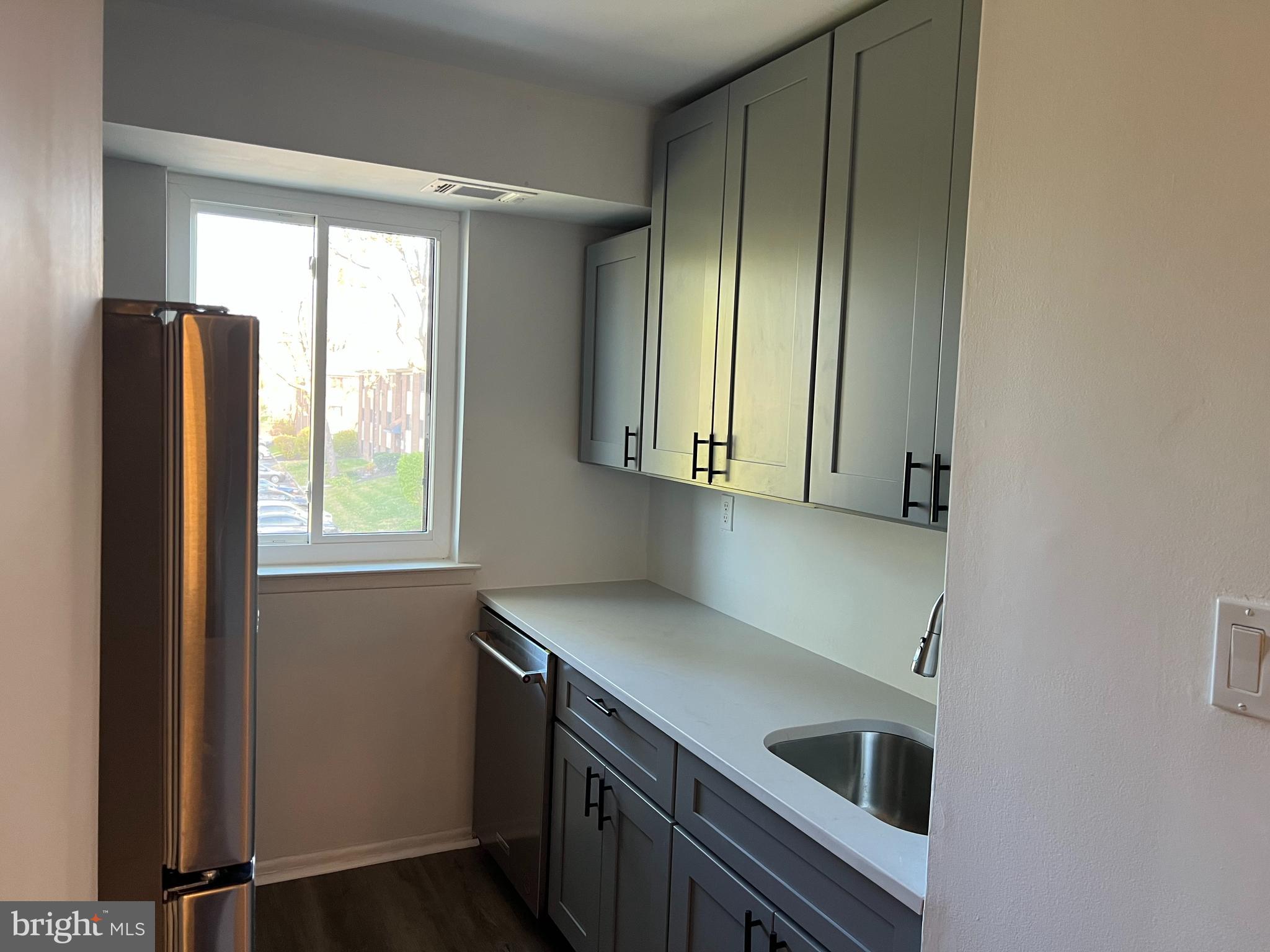 9921 Bustleton Avenue, Unit Q9 Philadelphia, PA 19115 - Photo 8 of 19 a kitchen with stainless steel appliances granite countertop a refrigerator and a sink