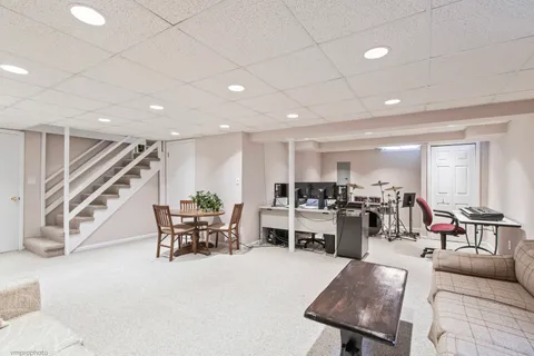 a living room with lots of furniture and kitchen view
