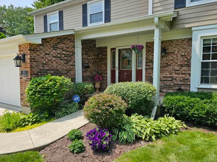 front view of a brick house with a large windows