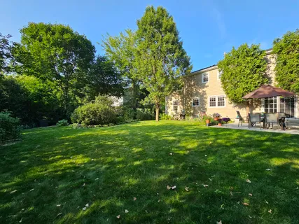 a view of a yard with a house in the background