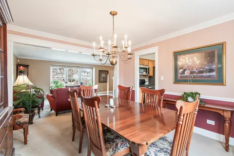 a dining room with furniture a livingroom and chandelier