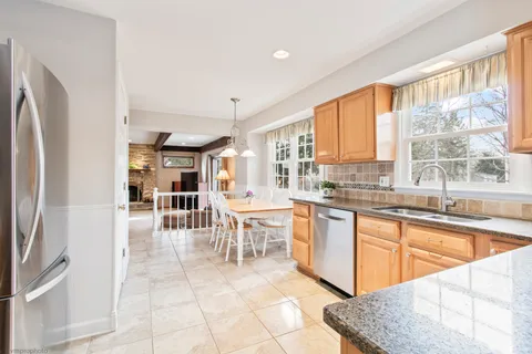 a kitchen with stainless steel appliances granite countertop a refrigerator and a sink
