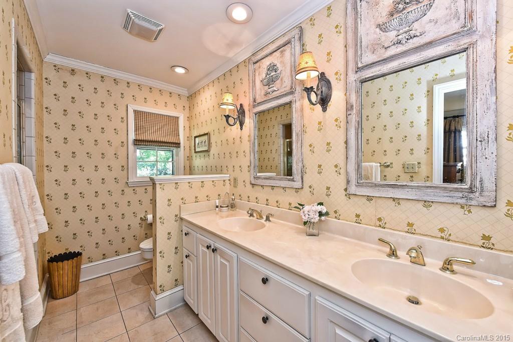 3118 Ferncliff Road Charlotte, NC 28211 - Photo 11 of 24 a bathroom with a double vanity sink a toilet a mirror and shower
