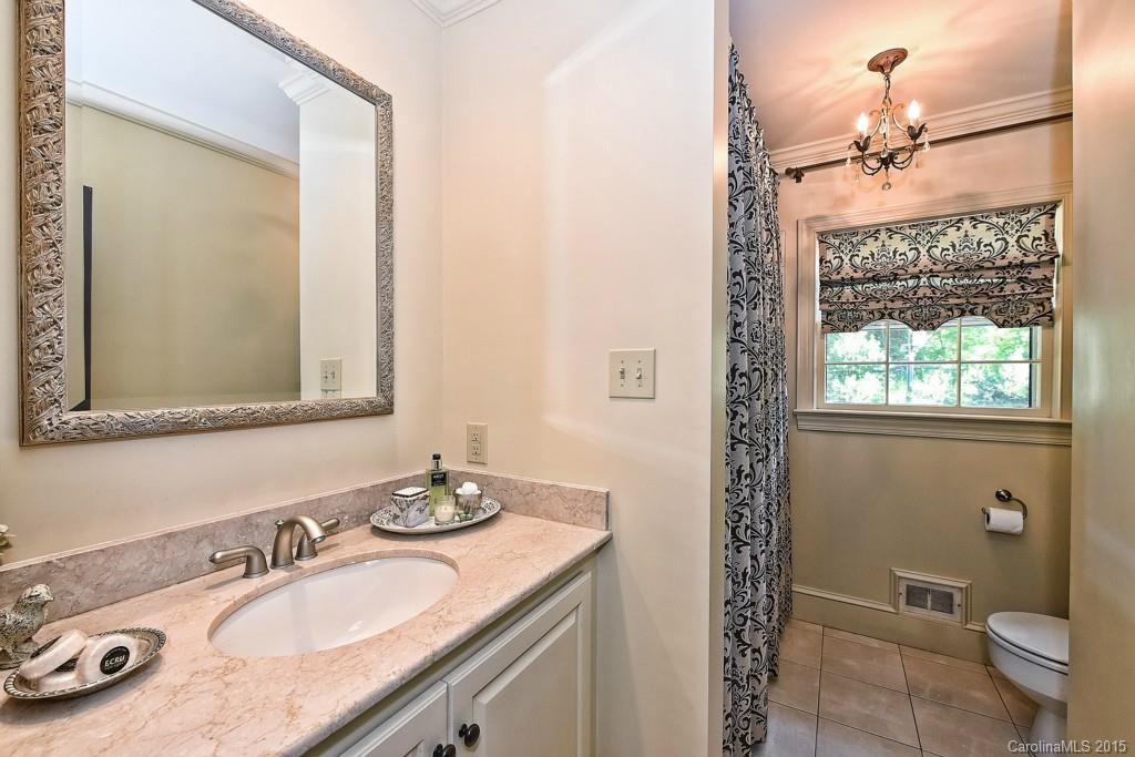 3118 Ferncliff Road Charlotte, NC 28211 - Photo 14 of 24 a bathroom with a granite countertop sink a mirror and a toilet