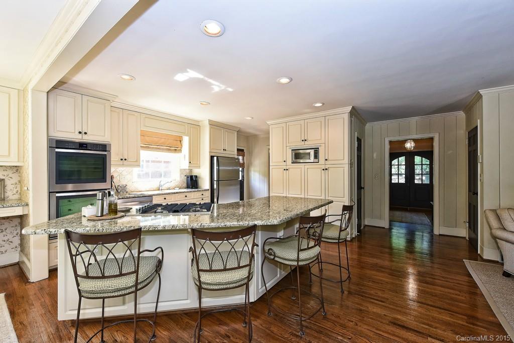 3118 Ferncliff Road Charlotte, NC 28211 - Photo 5 of 24 a kitchen with a dining table chairs and refrigerator