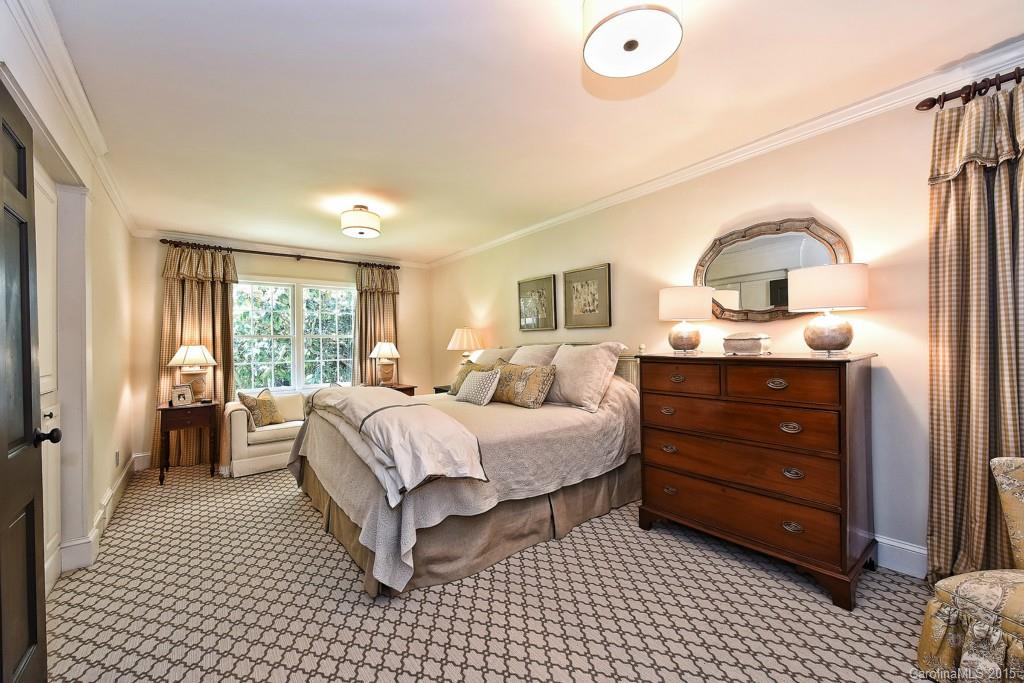 3118 Ferncliff Road Charlotte, NC 28211 - Photo 10 of 24 a spacious bedroom with a bed and a dresser next to a window