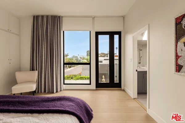 a bedroom with a large bed and a window