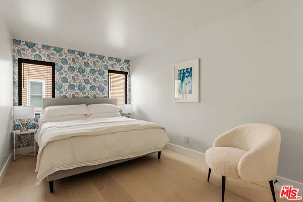 a bedroom with a bed chair and window