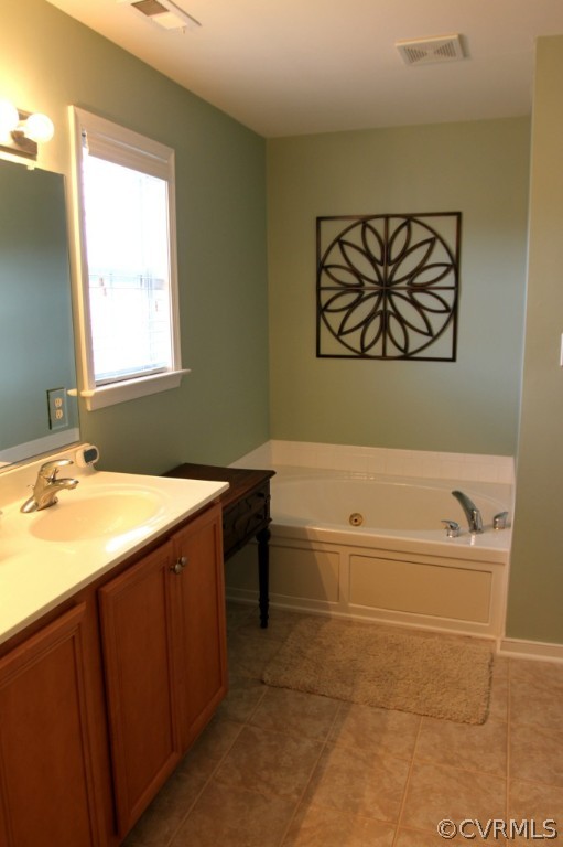 2930 Burley Ridge Terrace Chester, VA 23831 - Photo 13 of 24 a bathroom with a tub sink and a window