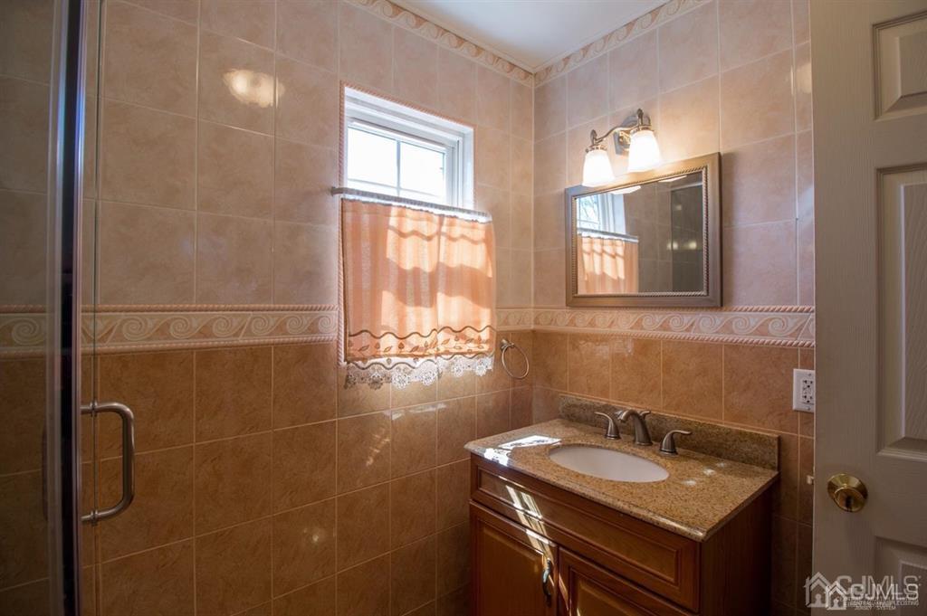 190 Midfield Road Colonia, NJ 07067 - Photo 13 of 17 a bathroom with a sink and a mirror