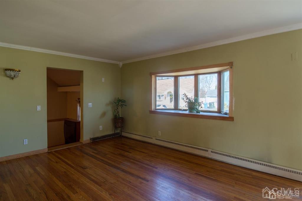 190 Midfield Road Colonia, NJ 07067 - Photo 3 of 17 a view of an empty room with wooden floor and a window