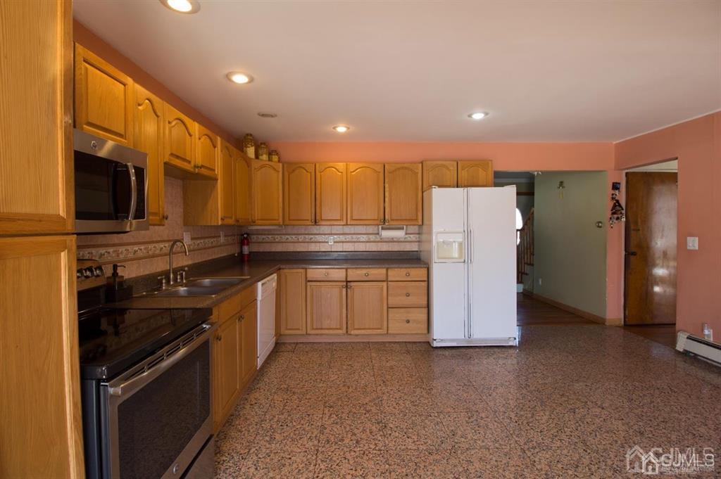190 Midfield Road Colonia, NJ 07067 - Photo 4 of 17 a kitchen with a refrigerator and a stove top oven