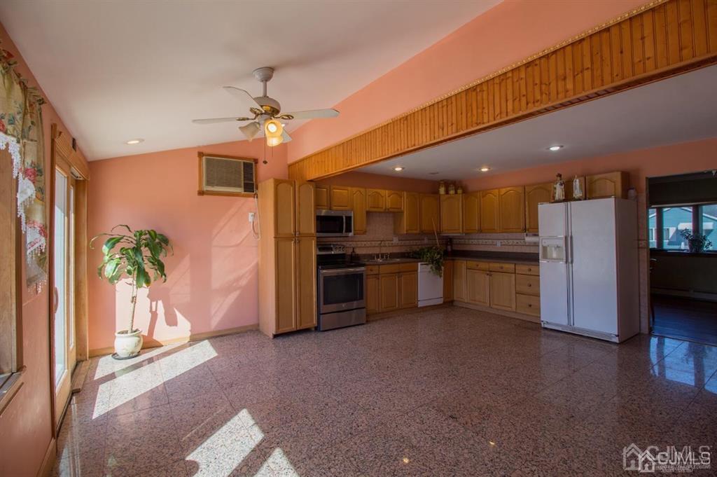 190 Midfield Road Colonia, NJ 07067 - Photo 6 of 17 a kitchen with stainless steel appliances kitchen island granite countertop a refrigerator a stove and a sink