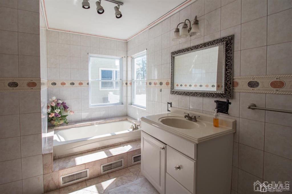 190 Midfield Road Colonia, NJ 07067 - Photo 7 of 17 a bathroom with a sink and a mirror
