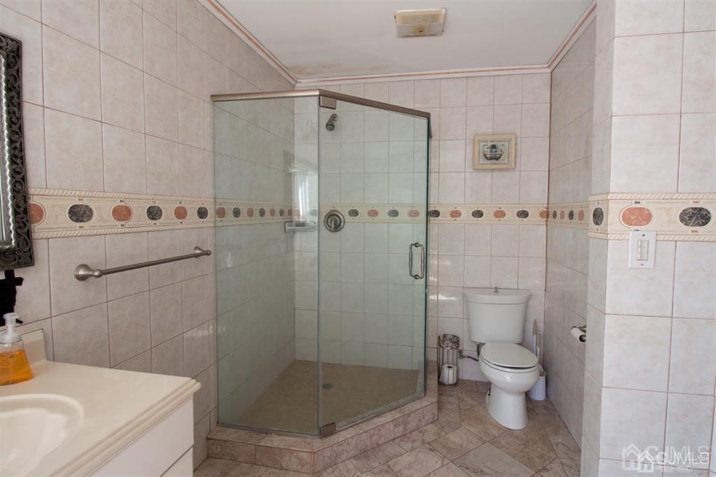 190 Midfield Road Colonia, NJ 07067 - Photo 8 of 17 a bathroom with a shower a toilet and a sink
