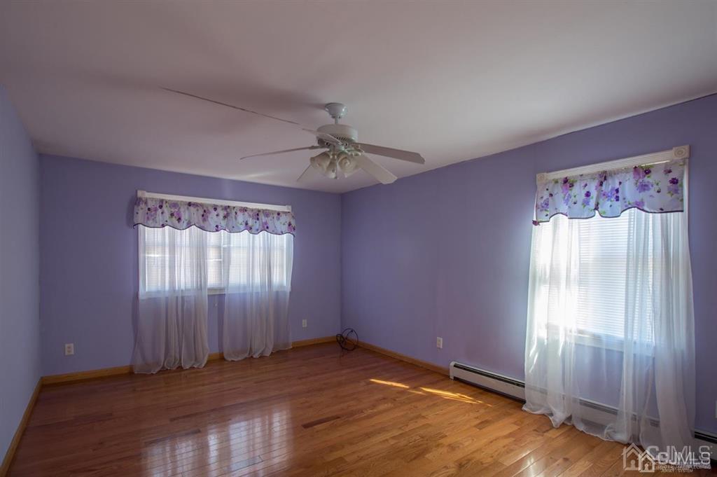 190 Midfield Road Colonia, NJ 07067 - Photo 10 of 17 an empty room with wooden floor closet and windows