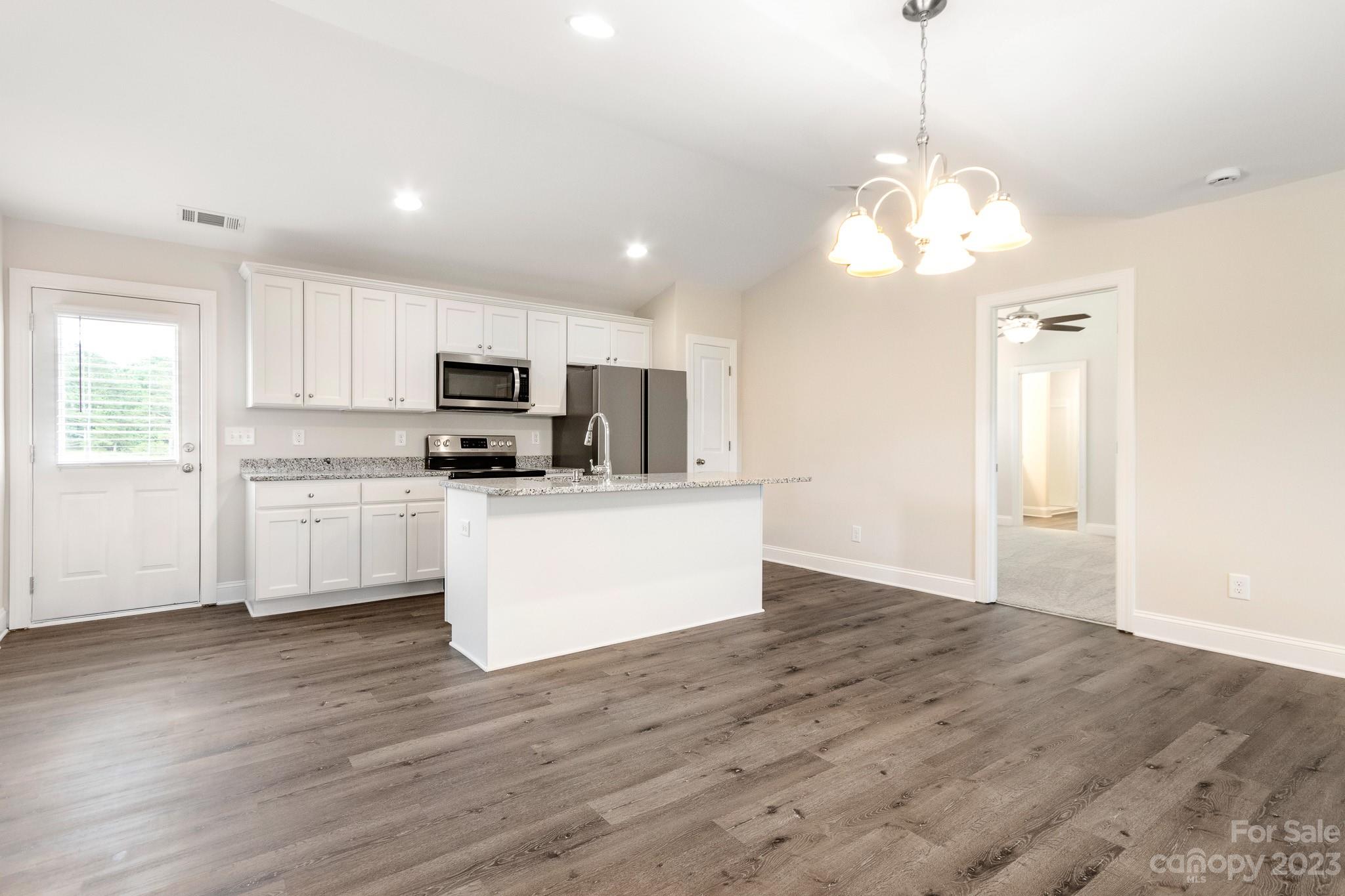 1509 Rehobeth Church Road Shelby, NC 28150 - Photo 16 of 34 a view of a kitchen with granite countertop stainless steel appliances cabinets and a counter top space
