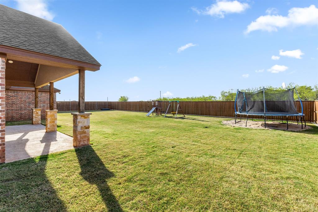 515 Sales Road Windthorst, TX 76389 - Photo 34 of 34 a view of a swimming pool with an outdoor seating and a yard
